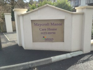 Maycroft Manor Care Home entrance sign with phone number