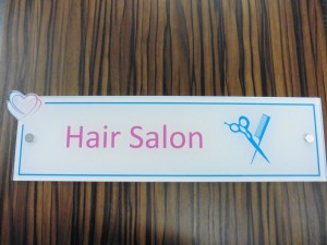 Close up of Hair salon sign on door