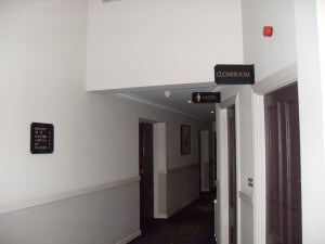 Corridor with ladies and cloakroom signage
