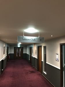 Hanging Sign in Hotel Corridor