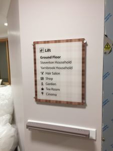 directional dementia signage with lift graphic