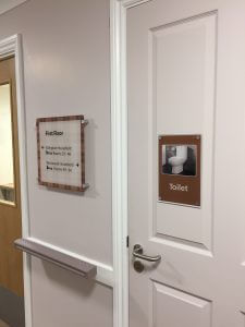 toilet dementia signage and first floor sign on door