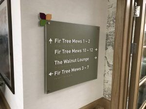 Care home directional sign with braille