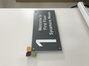 Internal care home sign with braille
