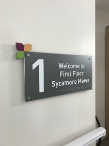Internal care home sign with braille